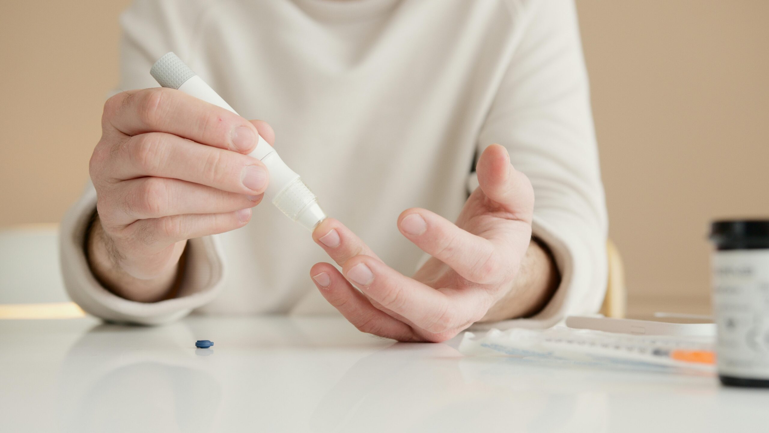 A person performing a fingertip blood test A person performing a fingertip blood test